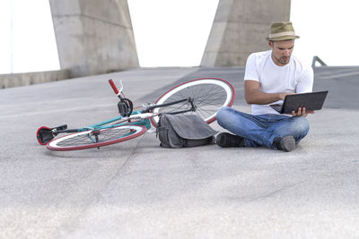 Portrait of man sitting on street