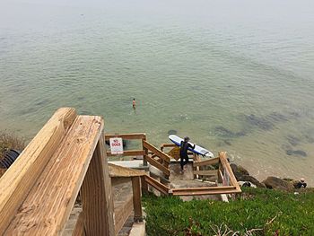 People sitting on pier in lake