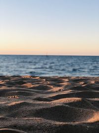 Scenic view of sea against clear sky during sunset