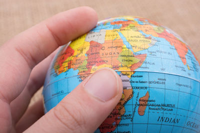 Close-up of hand holding globe