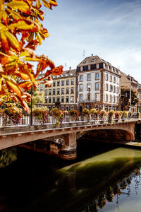 Arch bridge over river against sky