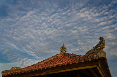 Low angle view of building against cloudy sky