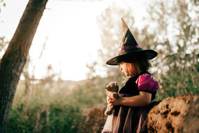 Side view of woman wearing hat