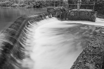 Black and white photo of a waterfall in cheddar village in somerset