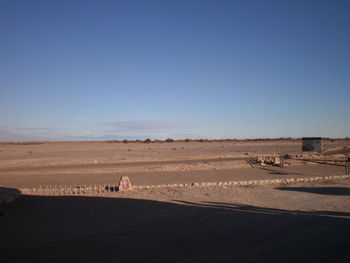 Scenic view of desert against clear blue sky
