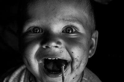 Portrait of cute baby boy eating lollipop