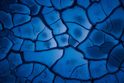 Nature's abstract canvas. blue cracked mud artistry in northern europe