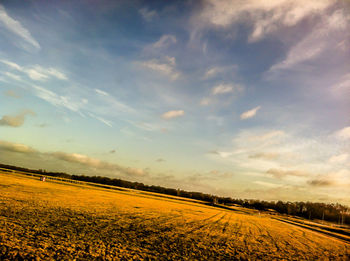 Scenic view of landscape against cloudy sky