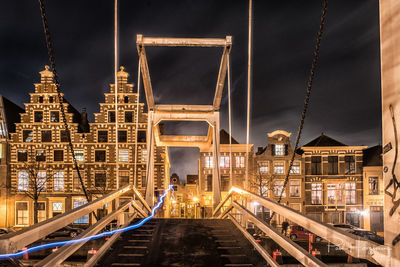 Low angle view of illuminated bridge at night