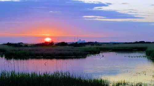 Scenic view of lake against sky during sunset