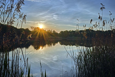 Scenic view of lake against sky at sunset