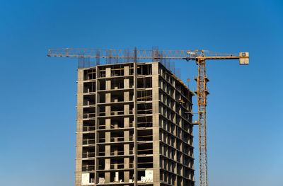 Low angle view of building against clear blue sky