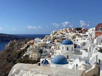 Panoramic view of buildings and sea against blue sky