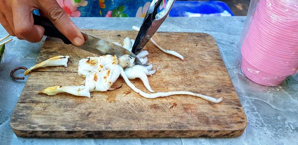 High angle view of person preparing food on cutting board