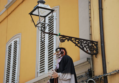 Full length of woman standing against building