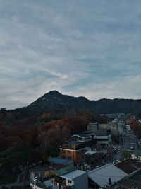 High angle view of townscape and mountains against sky