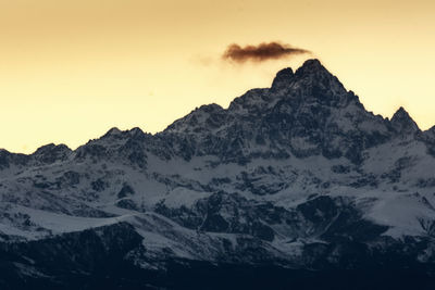 Scenic view of snowcapped mountains against sky during sunset