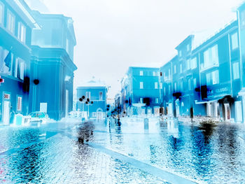 People swimming in pool against sky
