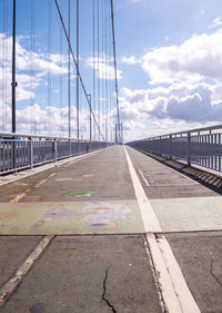 Bridge over road in city against sky