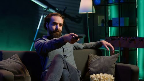 Low angle view of woman sitting on sofa at home