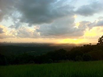 Scenic view of field against cloudy sky