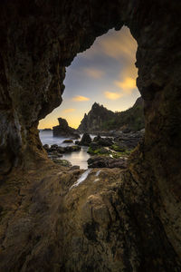 Scenic view of sea seen through cave