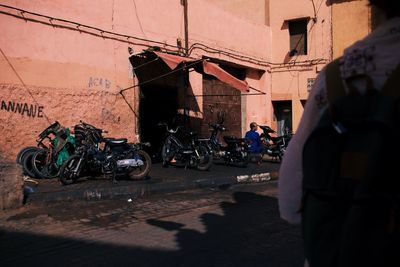 People on street against buildings in city