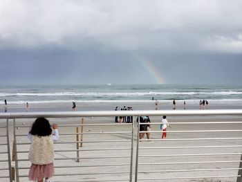 People on beach against sky