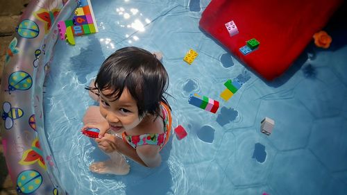 Portrait cute smiling girl in wading pool