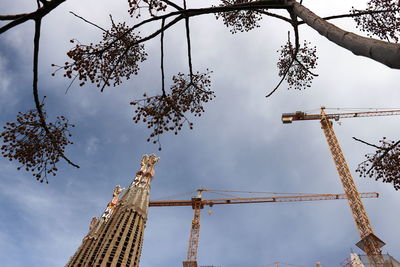 Low angle view of crane against sky