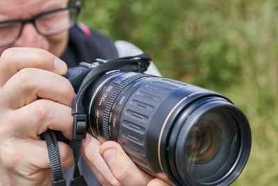 Close-up of man photographing camera