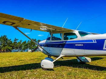 Airplane on field against sky