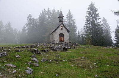 Mountain chapel surrounded by dust