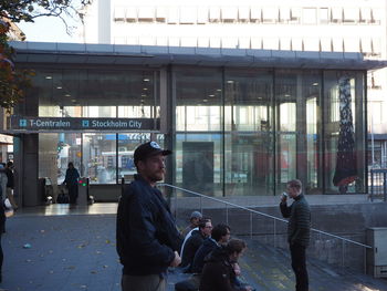 People walking in glass building