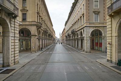 Empty street amidst buildings in city