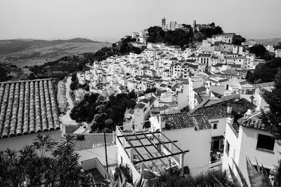 High angle view of houses in town against clear sky