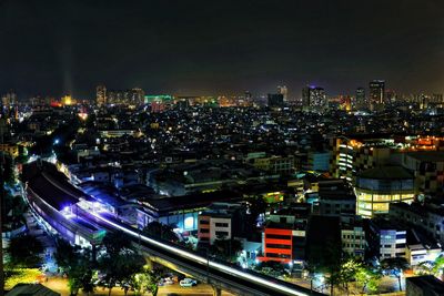 High angle view of illuminated city buildings at night