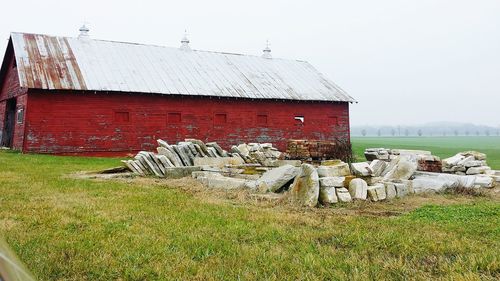 Abandoned structure on grassy field