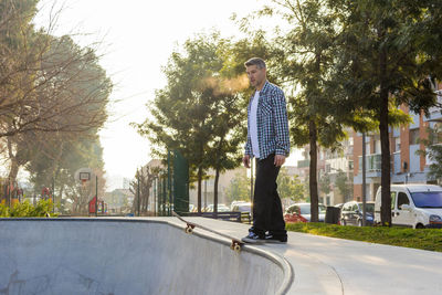 Man skateboarding on ramp in park