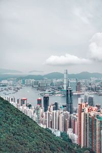 Buildings by sea against sky in city