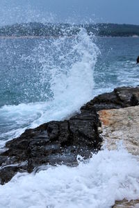View of waves splashing on rocks