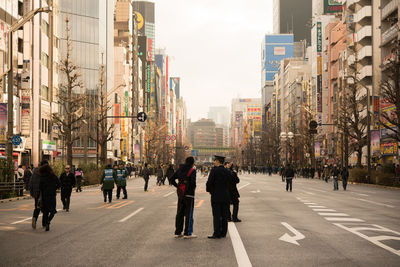 People on city street amidst buildings