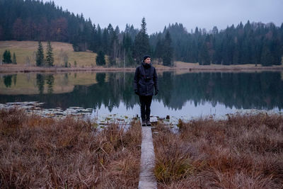 Full length of man standing on riverbank