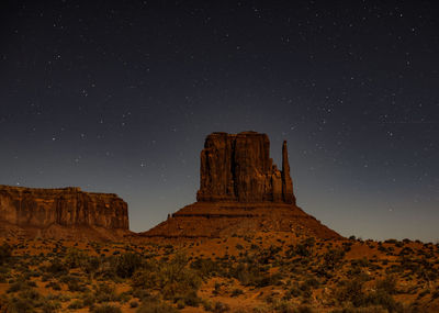 Low angle view of rock formation against sky at night