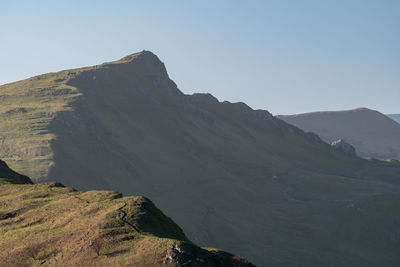 Scenic view of mountains against clear blue sky