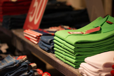 Close-up of shirts on shelf for sale at store