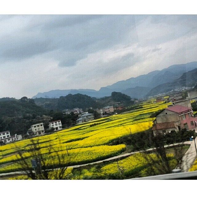 building exterior, sky, mountain, architecture, built structure, landscape, house, cloud - sky, agriculture, rural scene, residential structure, transfer print, residential district, nature, cloud, mountain range, residential building, farm, scenics, auto post production filter