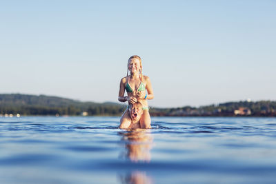 Girl and boy in lake