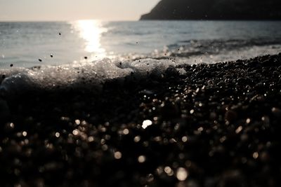 Close-up of sea against sky during sunset