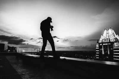 Silhouette of woman against sky